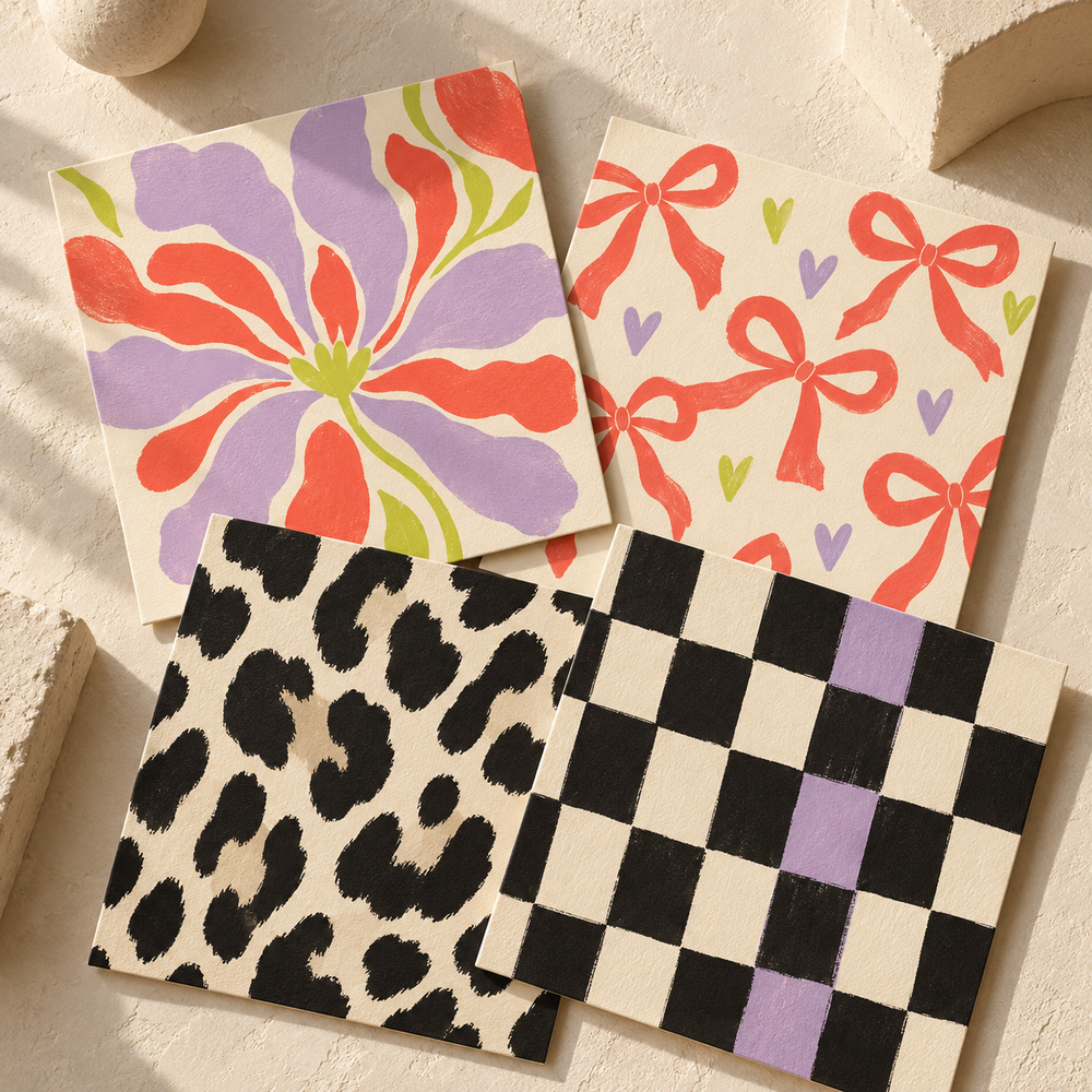 Four printed art cards featuring florals, bows and hearts, animal spots, and checks